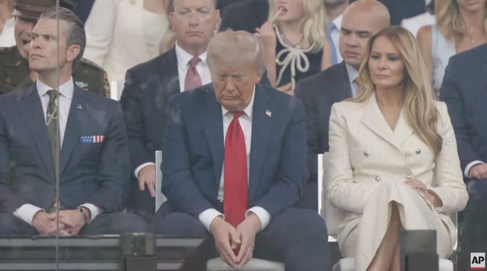 Sitting in the review stand at his parade, a clearly bored Trump stares at the ground