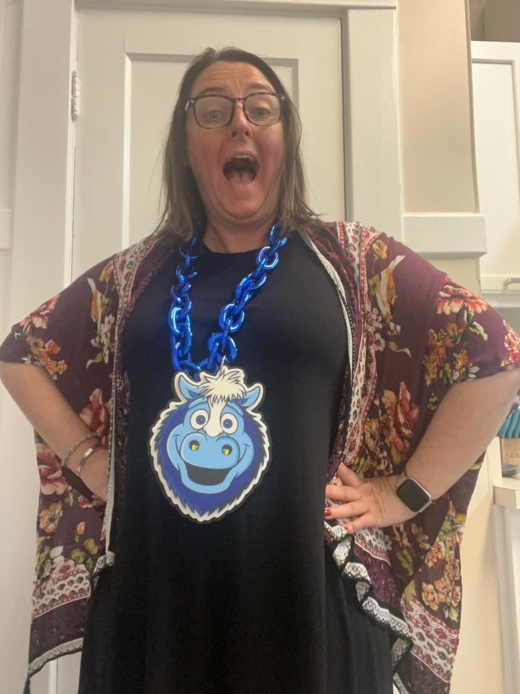 Woman excited to be wearing a Blue the Colt bling necklace. 