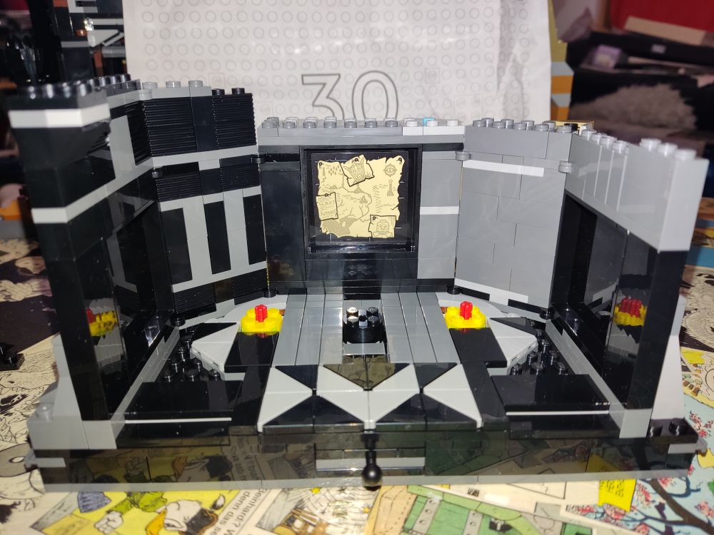 Picture of the "inside" (well... Can't really call it the inside when it's only half a room with one side completely open, can I?) of Sauron's room. There's a map of Middle Earth with pictures of gothmog and Sauron's Mouth pinned to it. 
The outside walls are complete now, the room is shaped like a half circle (like all other parts of the tower as well...)