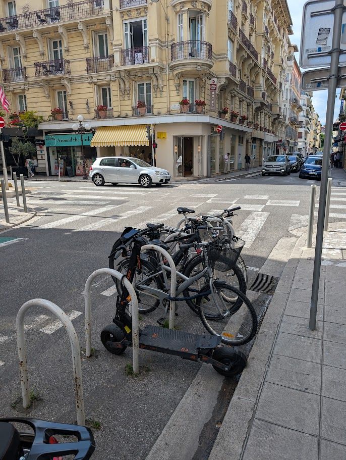 Bike racks daylighting an intersection in Nice.