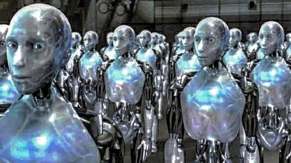 still from the i robot movie with a warehouse of all the robots staring blankly into space
