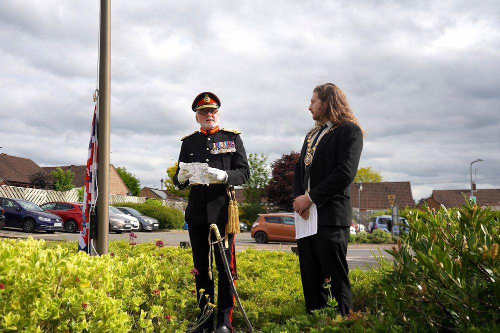 The parade marches to the flag pole.