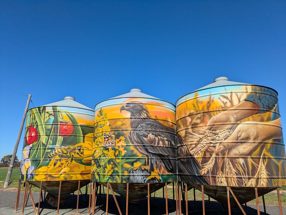 Three painted metal silos