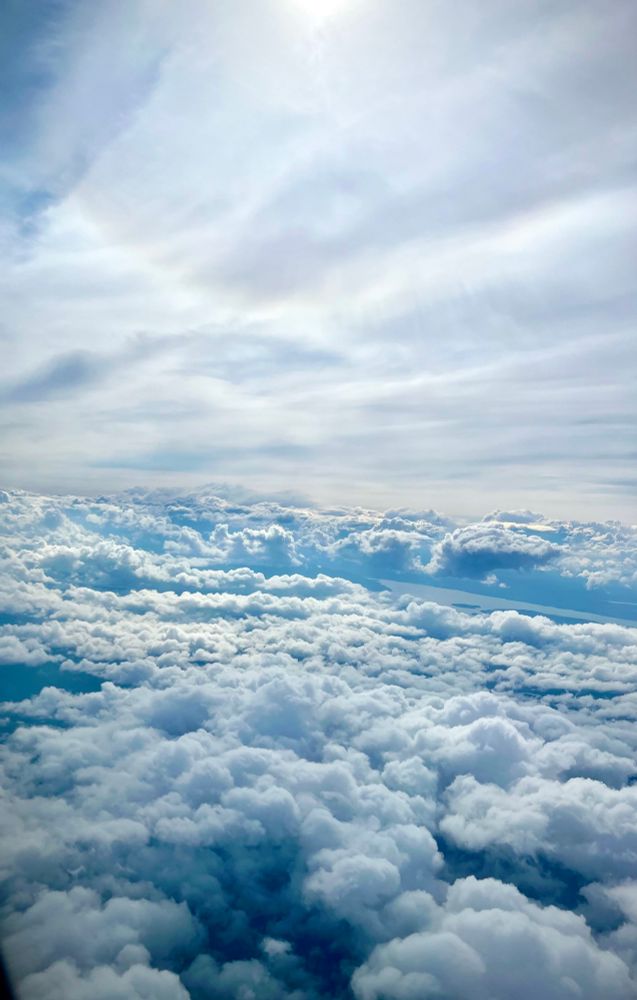 Beautiful dreamy fluffy sky, resembling cotton. It’s a gracious harmony in blue, heavenly blue. General feeling: indescribable fragile beauty, seemingly close, yet beyond reach. But it is the basic fabric for dreams. 

The picture was taken on a plane, overflowing Norway. 🇳🇴 
