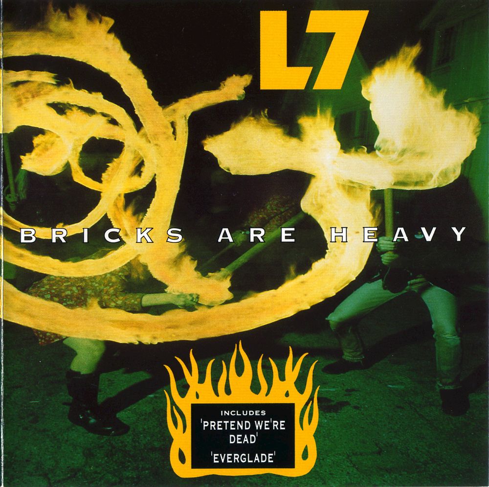 The frontcover of L7's 1992 Album, "Bricks are Heavy."

The cover is a green tinted night photograph of the band members swinging barbwire-wrapped baseball bats, with a yellowish light/fire effect obscuring much of the photo in serpentine patterns.
