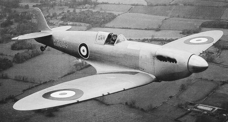 Prototype Spitfire Mk.I in flight. Light grey or silver finish with large pre-war tri-color roundels and no fin flash. Layout of 8x.303 machine guns in wings is evident. Interestingly, no exhaust collectors as seen on production aircraft. 