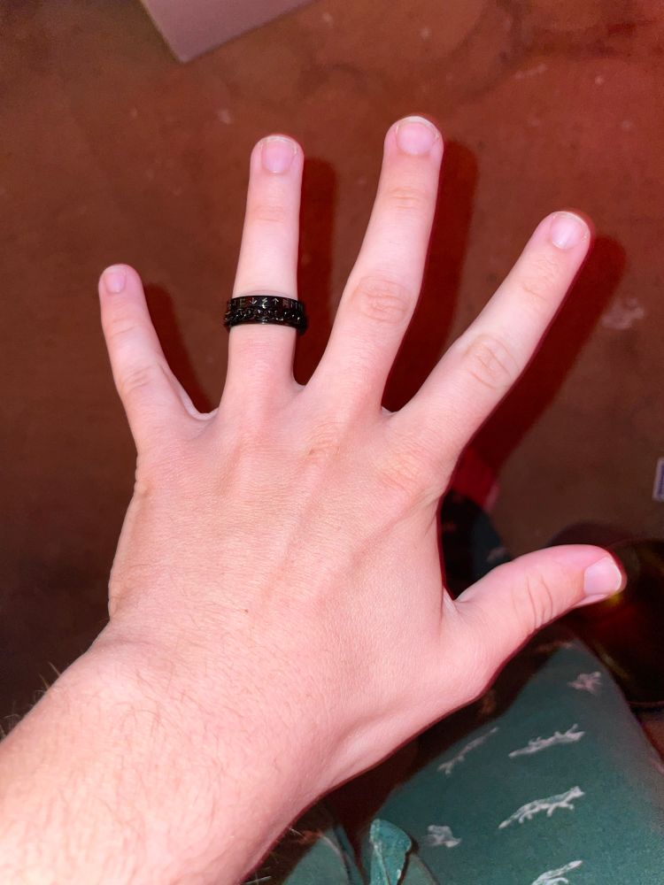 Hollow’s left hand with a ring on his left ring finger