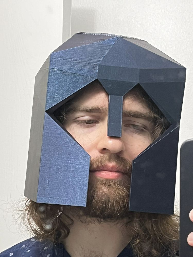me wearing a 3d printed helmet that looks like it's from medieval times, but low-poly