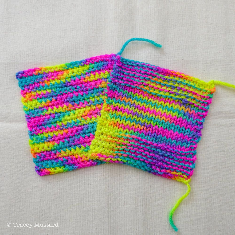 A crochet swatch sits on the left, slightly overlapped by a knitted swatch. Neon pink, blue, and yellow dance and pool in the fabric, with tiny pieces of orange and green at the ends of the yellow sections. 