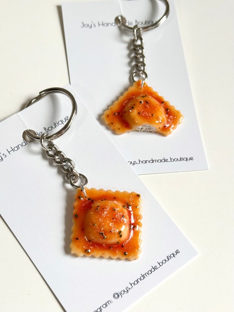 Miniature ravioli earrings with a bite out of one.