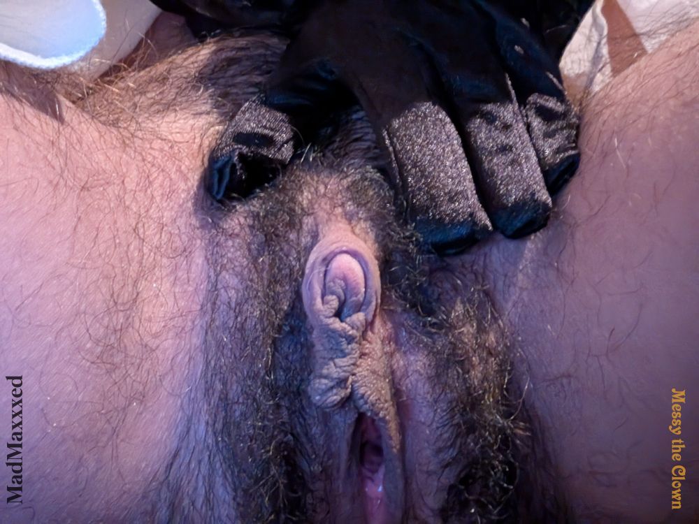 A trans Mexican american is in frame facing the camera.
The only things in frame are a hand and their genitals.
Their hand is pulling up their cock. They have on a silky black glove.
Their tip is pink, so is their hole which is gaping open and slick with juices.
Their lips look like balls, brown in color.
Their hole is gaped, and slick with juices.
They have dark brown pubic hair.