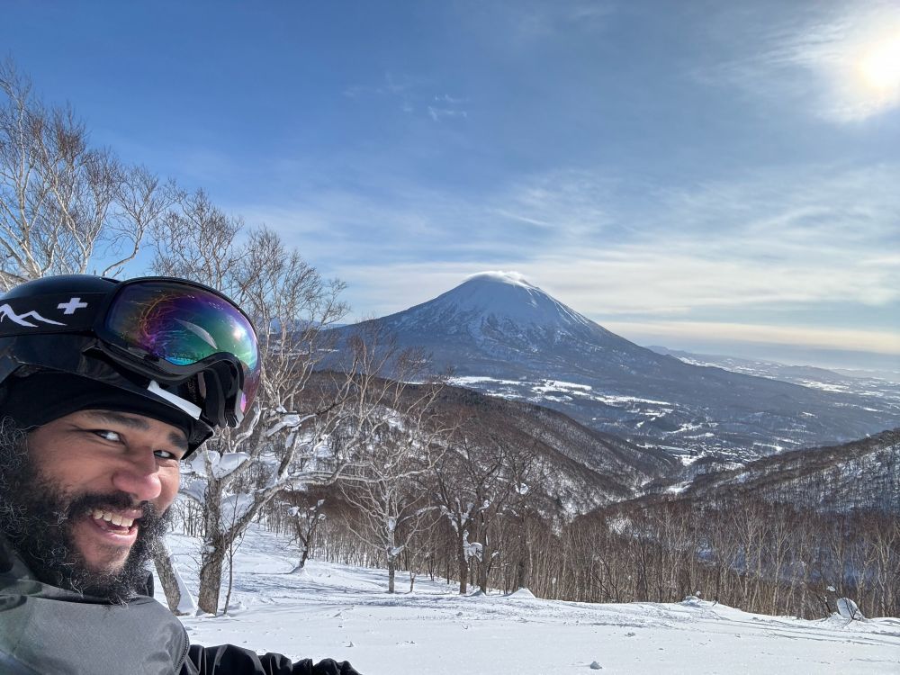 Mount Yōtei as viewed from Mount Niseko. @Penguin in foreground, strapped to a snowboard, smiling