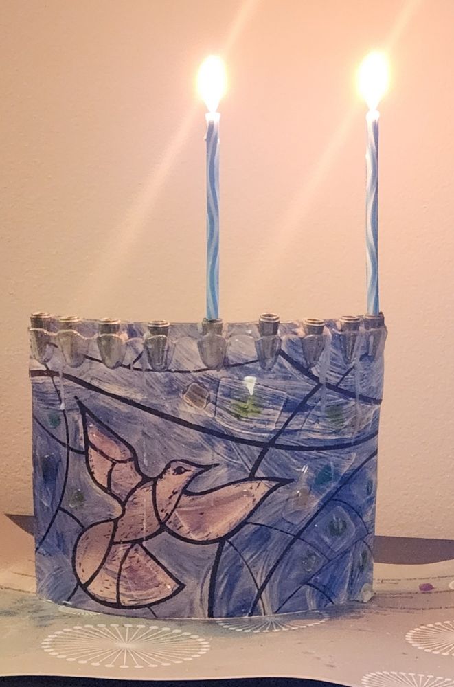 Menorah on first night of hanukkah, with two candles lit.