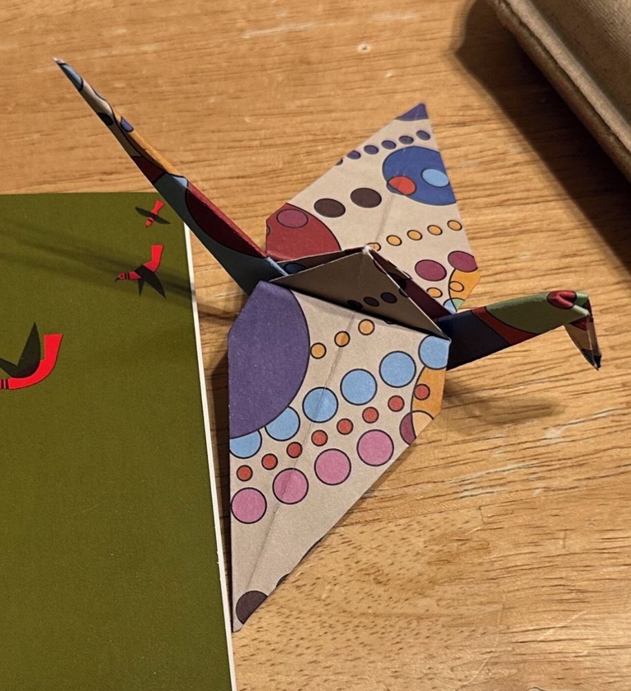 The paper crane folded on FLW inspired paper. The colors in the glass panel were drawn from this paper. 