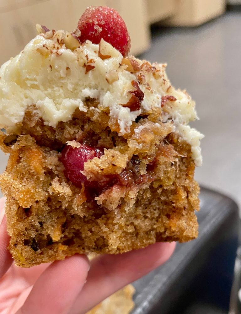 an image of the half eaten cupcake where the cranberry chutney in the center is visible 