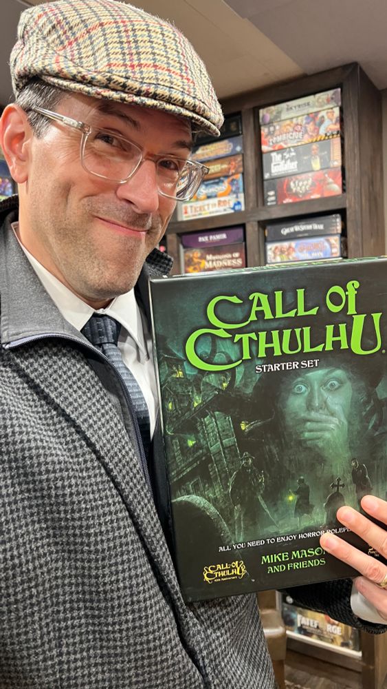 A guy holding a Call of Cthuhu starter box