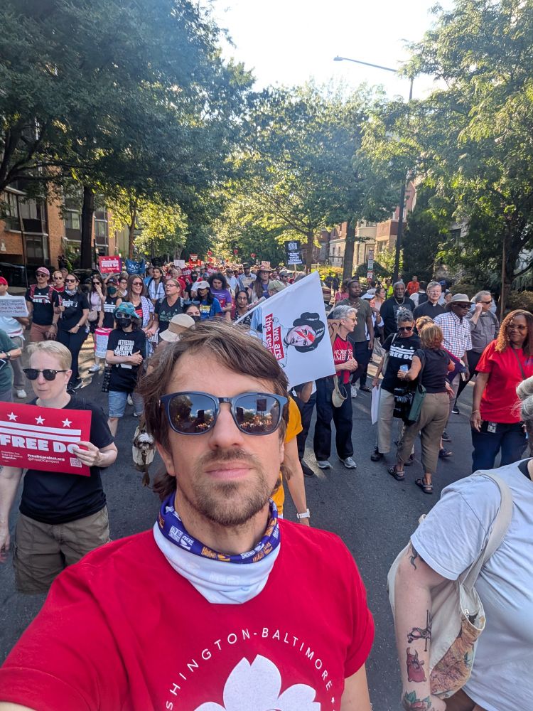 A large labor protest in DC with Evan taking a selfie in the middle. 