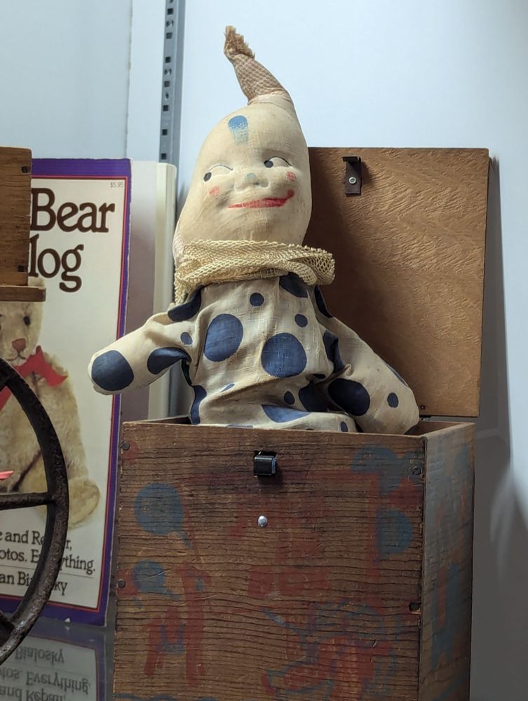 An antique Jack in the box. He wears a smug expression.