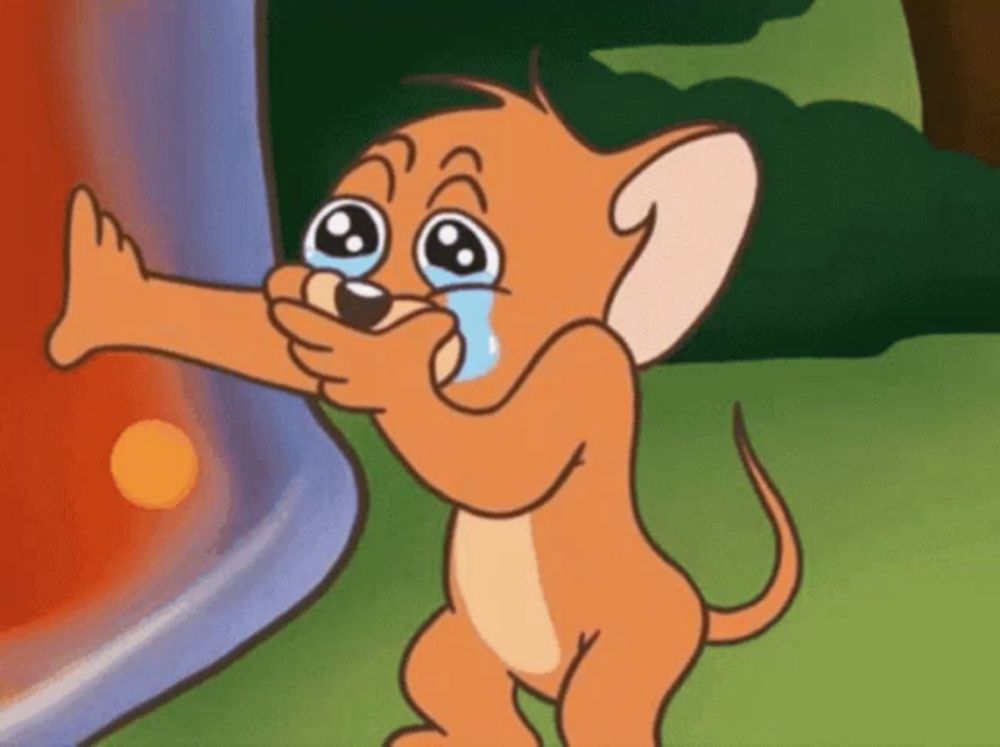 jerry from tom and jerry is crying while holding a bottle