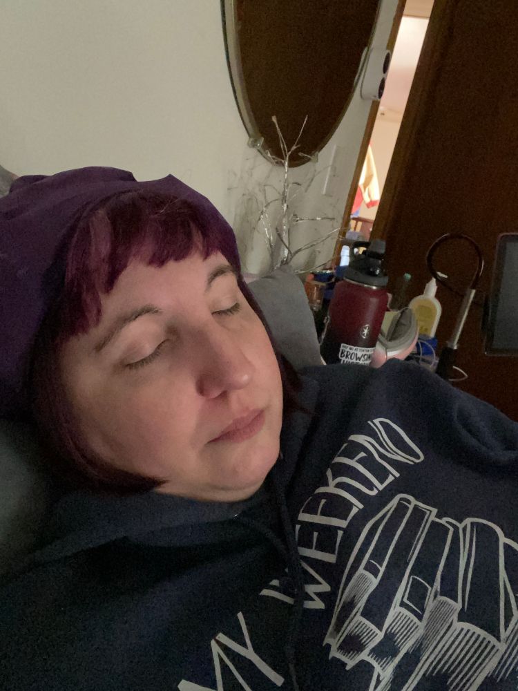Author Stormi Lewis resting with an ice cap on her head 