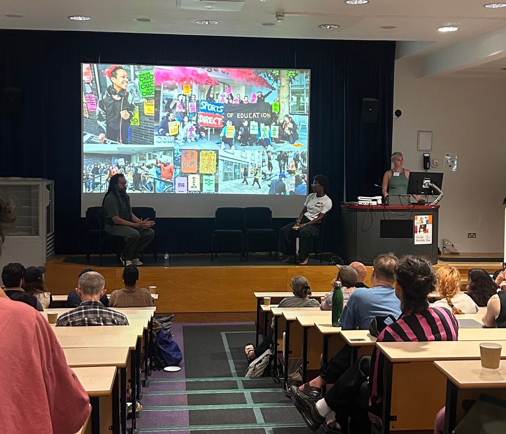 Apex Zero & Ekua McMorris speaking on stage in a lecture theatre.