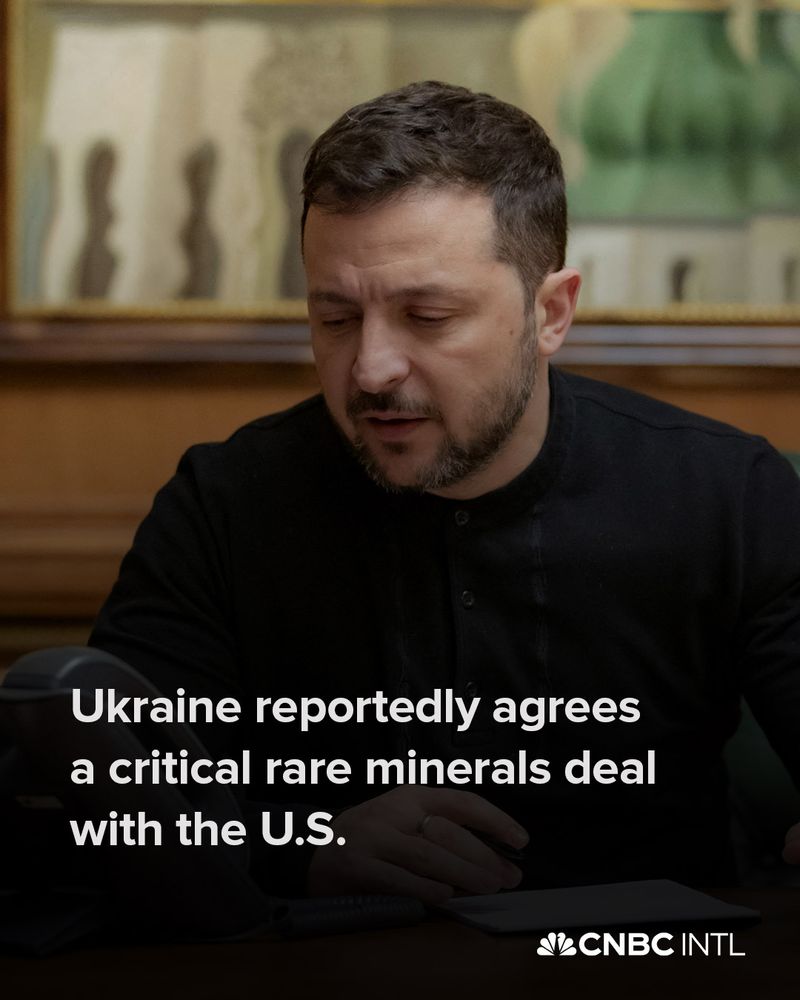 Image shows Ukraine's President Volodymyr Zelensky sat at a desk, looking at a landline phone. On the image, the headline reads: Ukraine reportedly agrees a critical rare minerals deal with the U.S.