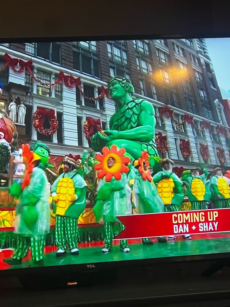 macy’s thanksgiving day parade float with a two story statue of the very sexy jolly green giant