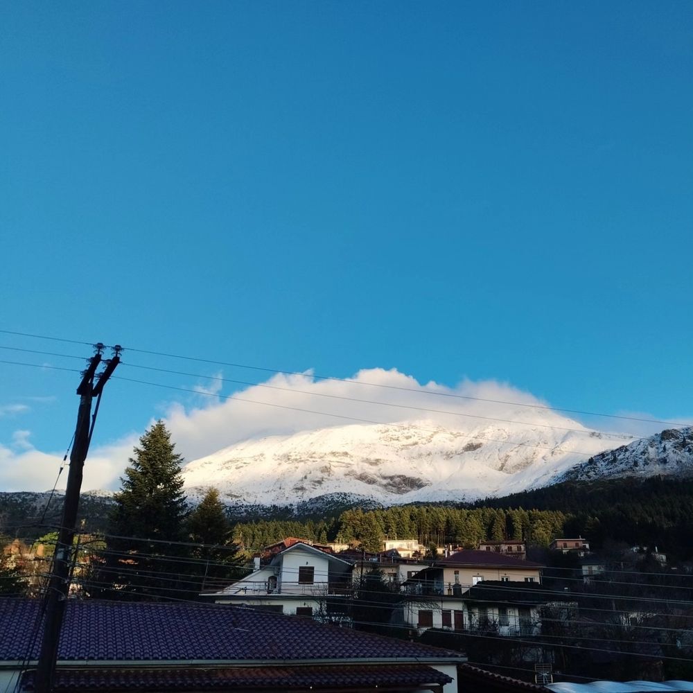 A photo with snow on the mountain's peak.