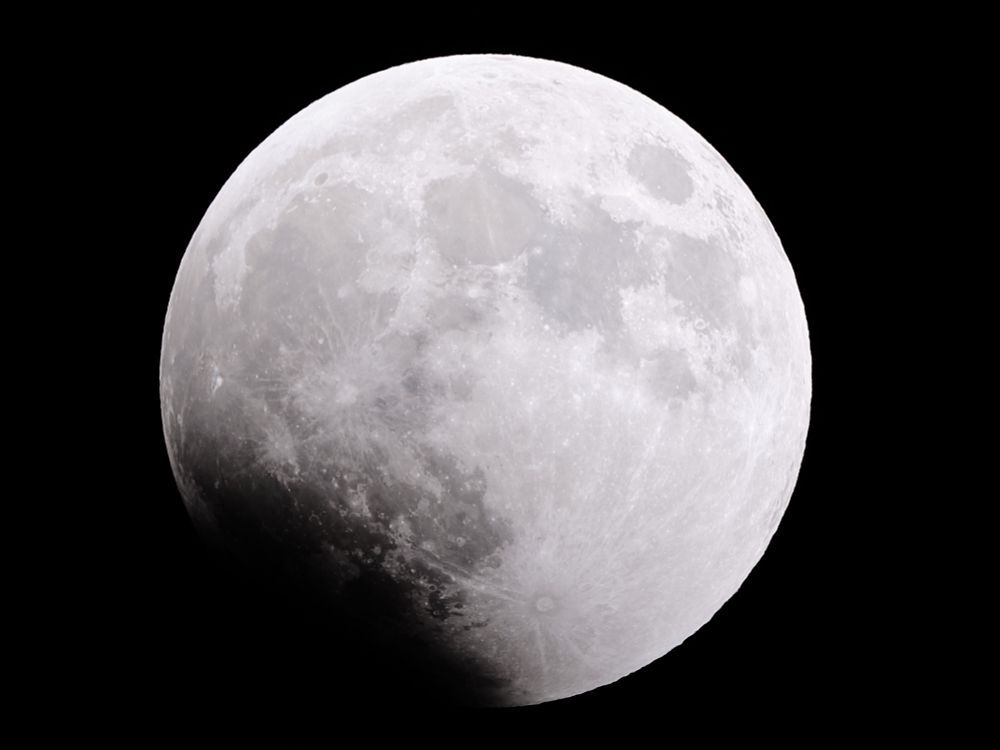 Moon at its fullest when I went out to take pictures of the eclipse. The moon is bright with a creeping shadow coming up from the bottom left