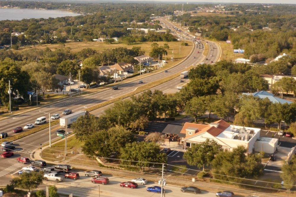 a photograph of an intersection below the tower. The road stretches on for the entire frame of the photo