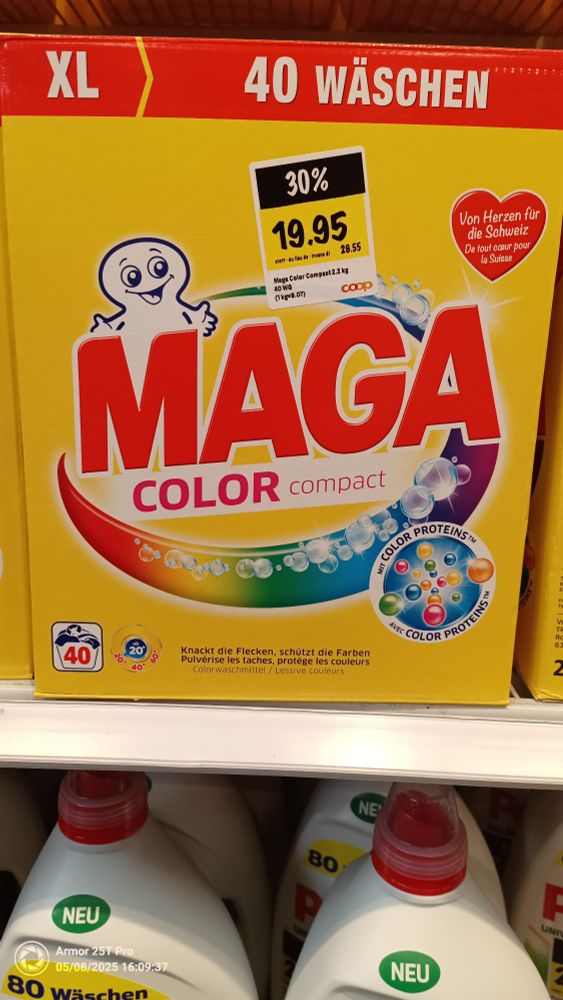 A picture of a box of detergent called MAGA Color.
The box is yellow and has a small smiling ghost hiding behind the M of the word "Maga".
Below the word maga is the word "color" written

The whole text had a big sparkling circle in all colors of the rainbow behind it.