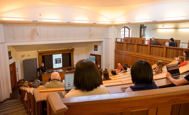 Prof Julianne Nyhan giving the Susan Hockey Lecture 2025, with audience in the foreground