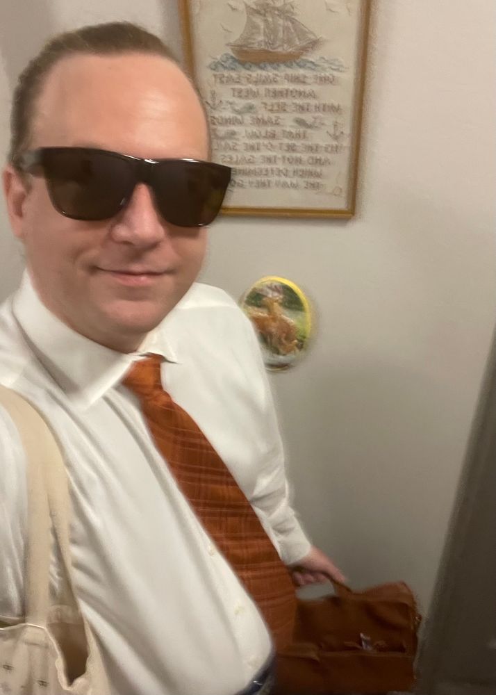 Mudd in tie with briefcase and sunnies