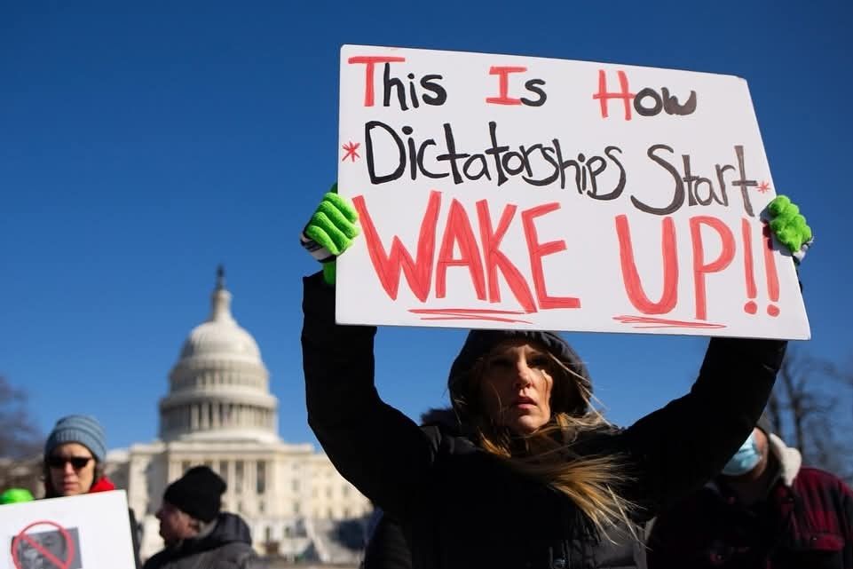 A sign Says, This is how dictatorships start. Wake up!