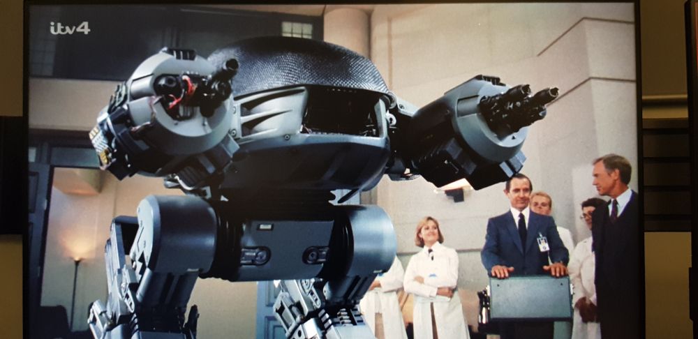 Screenshot. ED 2 0 9 in the original Robocop, a killer robot cop that's a little "glitchy".