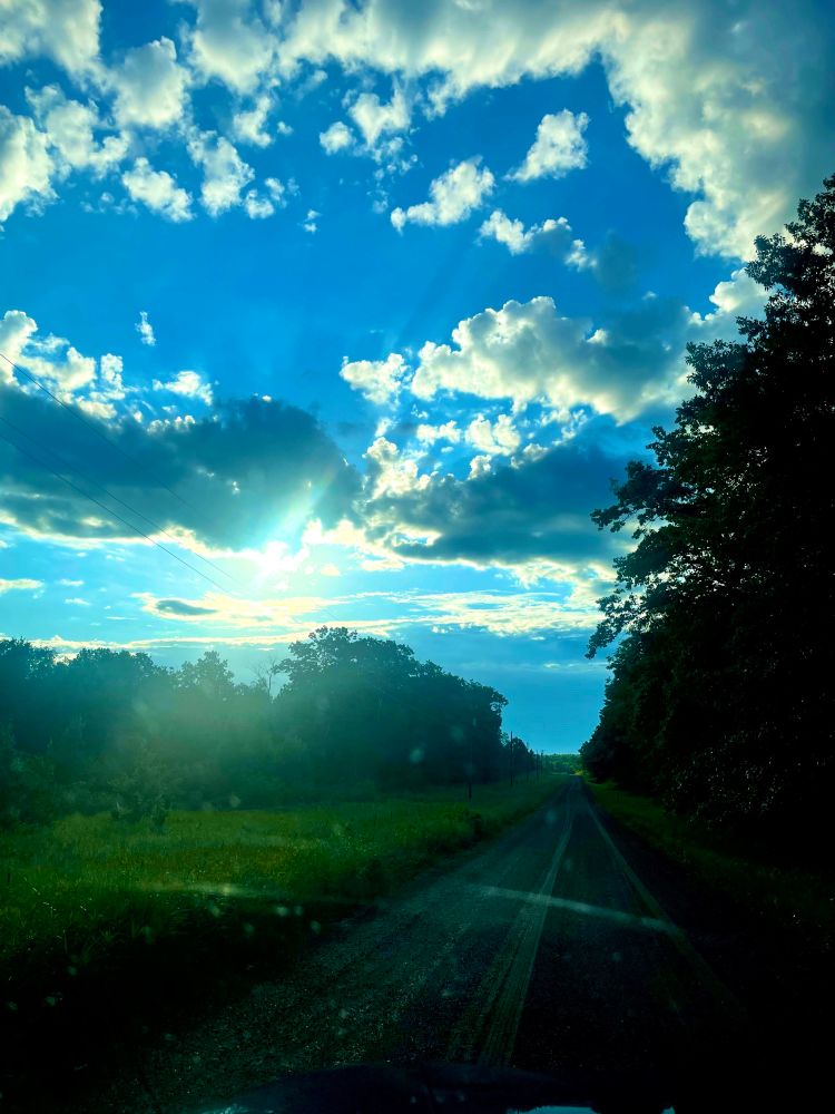 Coming out of the driveway yesterday and witnessed an amazing sunrise of blue sky and white clouds.