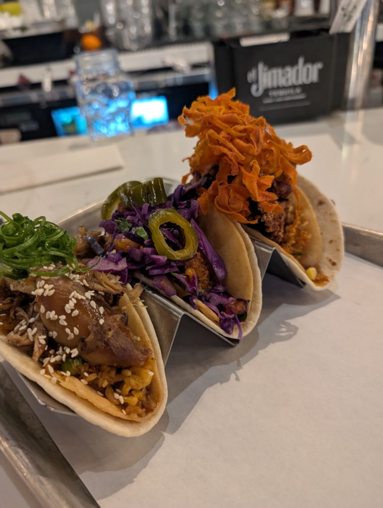 Picture of three tacos. All different. Delicious looking 