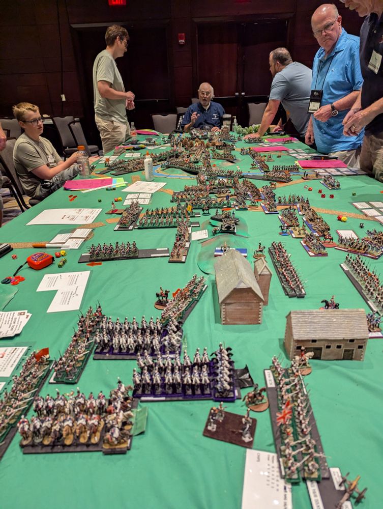 A gaming table filled with well painted Napoleonic miniatures in battle at Historicon.