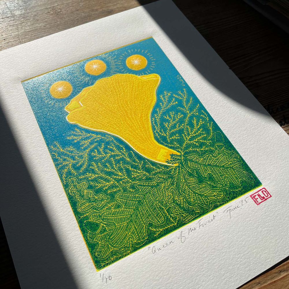 a linoprint of a yellow chantarelle mushroom among moss and oak leaves