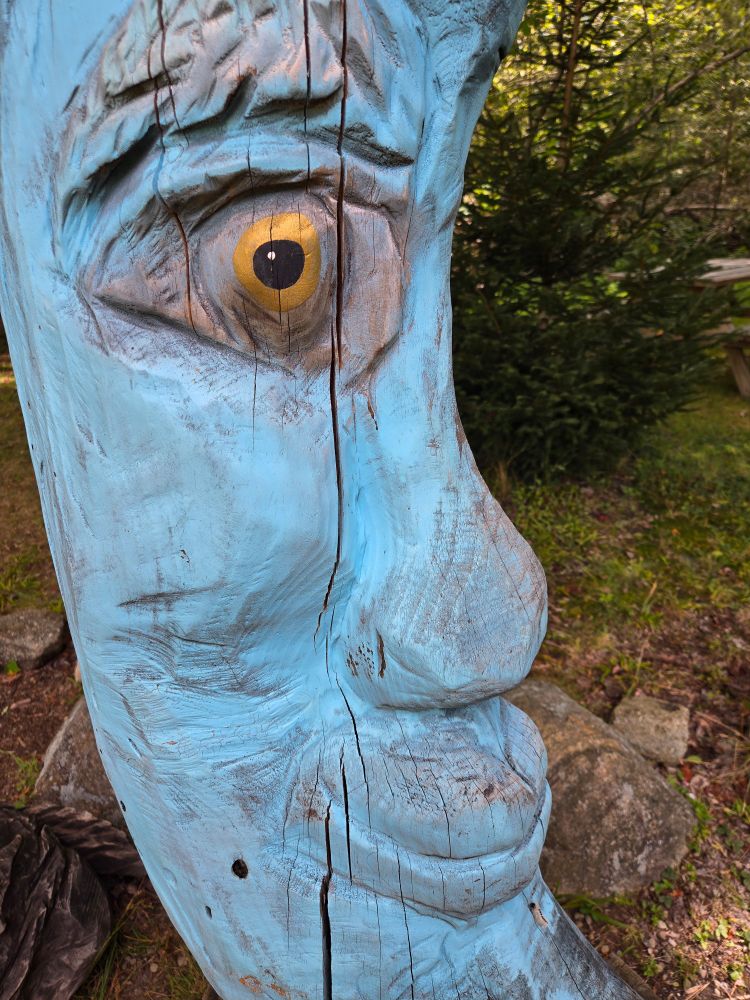 A wooden sculpture outside a park.
That's all the context I will provide. 