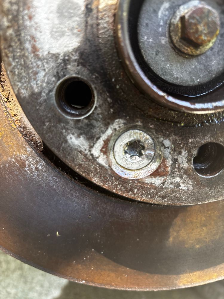 The retaining bolt for Volvo V60 brake rotors, with a T50 bolt head about to strip out and threads that show no signs of moving in this lifetime.
