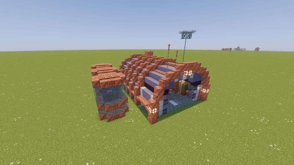 A wide-angle shot of a Minecraft building- a hangar themed around the upcoming Happy Ghast! The build is made mostly of Copper blocks and Light Blue Terracotta, with three large water tanks outside.