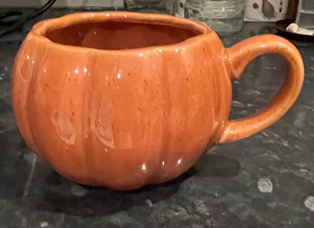 An orange pumpkin mug