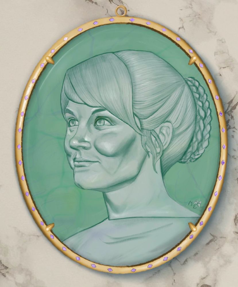 a green fluorite cameo set in an oval, gold pendant with small violet gems around its edge. The nearly white figure is Elizabeth Burke, smiling in 3/4 profile, with a simple braided bun. The pendant sits on a marble surface. 