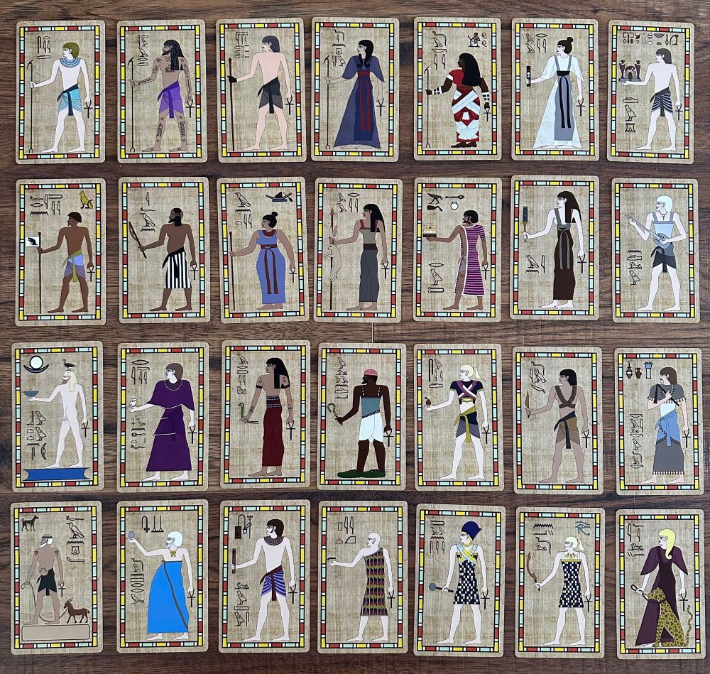 Photographs of 28 trading cards of OFMD characters drawn in ancient Egyptian art style