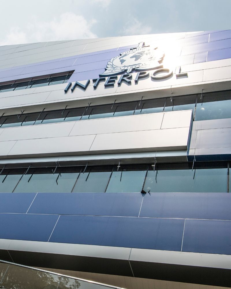 Picture of the futuristic facade of INTERPOL's Global Complex for Innovation in Singapore with the INTERPOL logo.