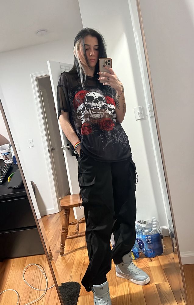picture of me (wearing a black skull shirt, baggy black pants and grey sneakers)