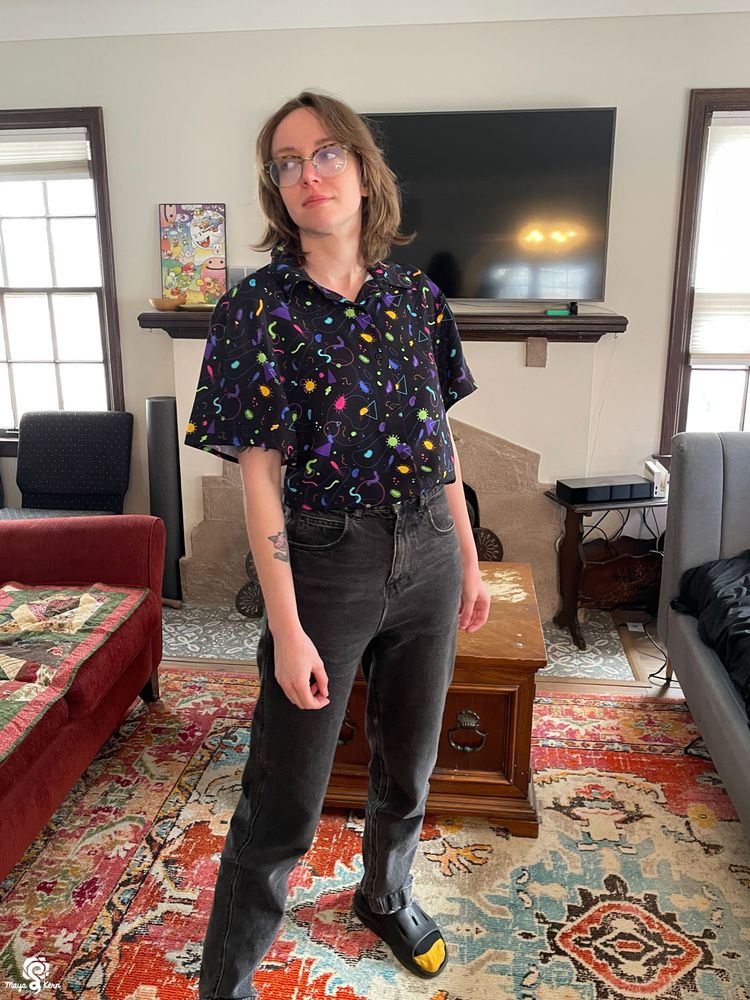 devin wearing the microorganisms button-up in size small