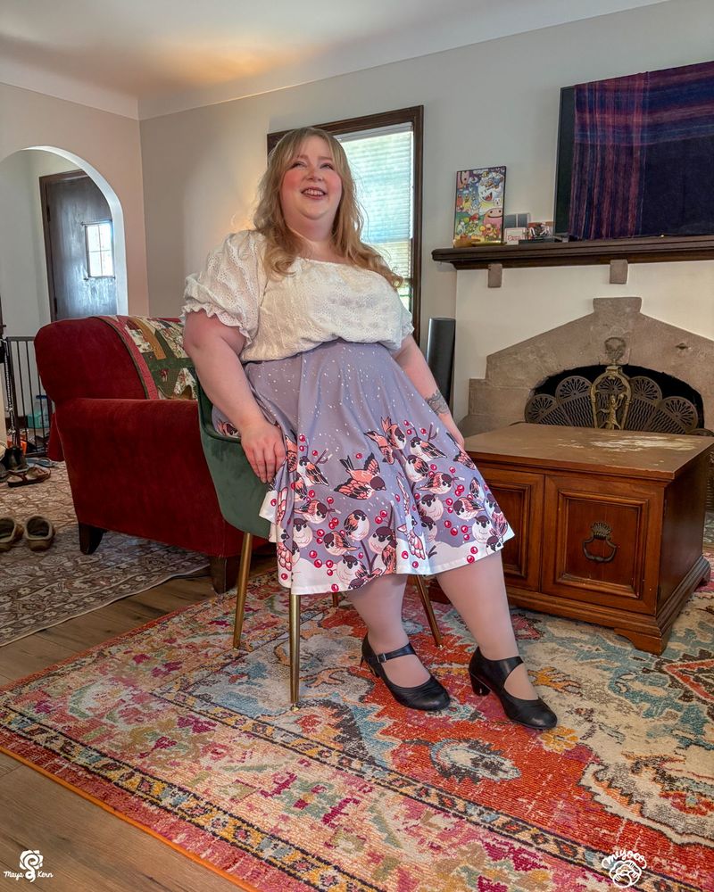 maya wearing meyoco's sparrow design in size 2XL-3XL. while seated the design is still clearly visible over the legs