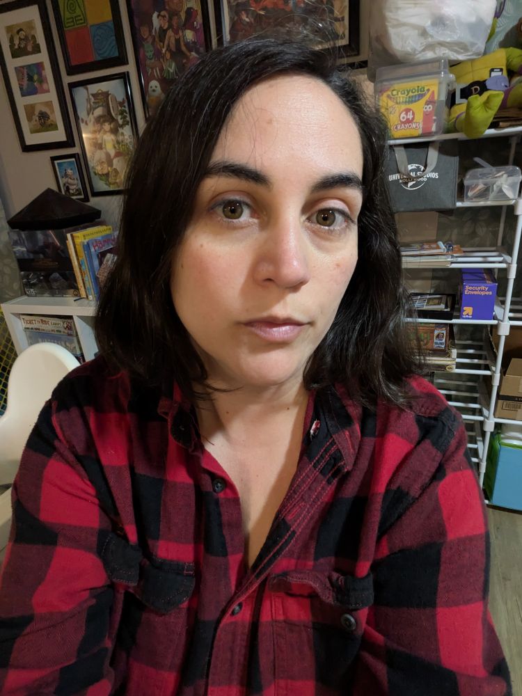 Red checkered button-down. Not smiling so you know I'm the one that's grumpy and needs said high-powered city businesswoman to rekindle my love of Christmas 